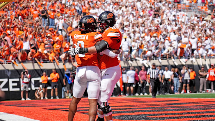 Oklahoma State's Ollie Gordon II (0) celebrates a touchdown with Preston Wilson (74) in double over time of the college football game between the Oklahoma State Cowboys and the Arkansas Razorbacks at Boone Pickens Stadium in Stillwater, Okla.,, Saturday, Sept., 7, 2024.