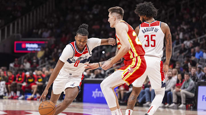 Oct 28, 2024; Atlanta, Georgia, USA; Washington Wizards guard Carlton Carrington (8) dribbles against Atlanta Hawks guard Vit Krejci (27) during the first half at State Farm Arena. Mandatory Credit: Dale Zanine-Imagn Images