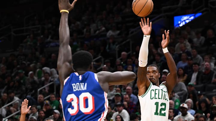 Oct 12, 2024; Boston, Massachusetts, USA; Boston Celtics guard Lonnie Walker IV (12) attempts a basket against Philadelphia 76ers center Adem Bona (30) during the second half at the TD Garden. Mandatory Credit: Brian Fluharty-Imagn Images
