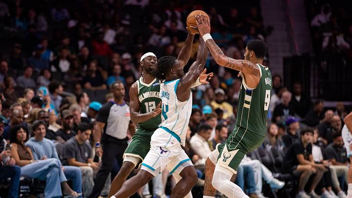 Oct 11, 2026; Charlotte, North Carolina, USA; Charlotte Hornets guard Sion James (4) splits Milwaukee Bucks guard Caris LeVert (12) and center Kel'el Ware (9) during the second half at Spectrum Center. Mandatory Credit: Scott Kinser-Imagn Images Oct 11, 2026; Charlotte, North Carolina, USA; Charlotte Hornets guard Sion James (4) splits Milwaukee Bucks guard Caris LeVert (12) and center Kel'el Ware (9) during the second half at Spectrum Center. Mandatory Credit: Scott Kinser-Imagn Images