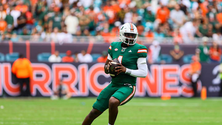 Nov 2, 2024; Miami Gardens, Florida, USA; Miami Hurricanes quarterback Cam Ward (1) looks for a passing option against the Duke Blue Devils during the first quarter at Hard Rock Stadium. Mandatory Credit: Sam Navarro-Imagn Images