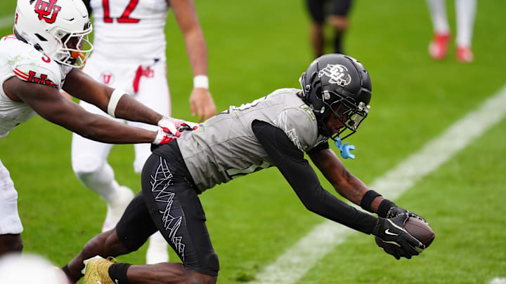 Nov 16, 2024; Boulder, Colorado, USA; Colorado Buffaloes wide receiver Travis Hunter (12) scores a touchdown in the fourth quarter against the Utah Utes at Folsom Field. Mandatory Credit: Ron Chenoy-Imagn Images