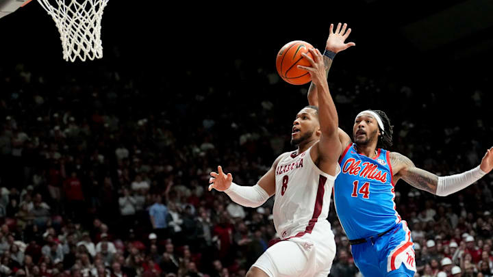 Jan 14, 2025; Tuscaloosa, AL, USA; Alabama guard Chris Youngblood (8) goes for a shot defended by Ole Miss guard Dre Davis (14) at Coleman Coliseum. Ole Miss defeated Alabama 74-64. Mandatory Credit: Gary Cosby Jr.-Tuscaloosa News