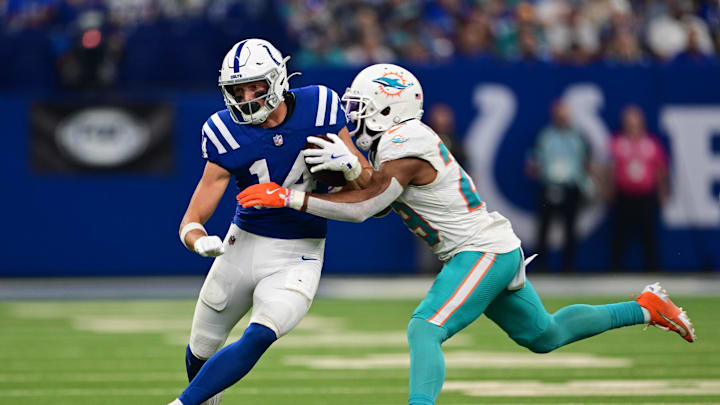 Oct 20, 2024; Indianapolis, Indiana, USA; Indianapolis Colts wide receiver Alec Pierce (14) is tackled by Miami Dolphins cornerback Kendall Fuller (29) during the second half at Lucas Oil Stadium. Mandatory Credit: Marc Lebryk-Imagn Images
