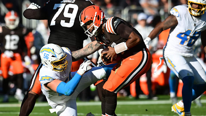 Nov 3, 2024; Cleveland, Ohio, USA; Los Angeles Chargers defensive end Morgan Fox (56) attempts to tackles Cleveland Browns quarterback Jameis Winston (5) during the first half at Huntington Bank Field. Mandatory Credit: Ken Blaze-Imagn Images