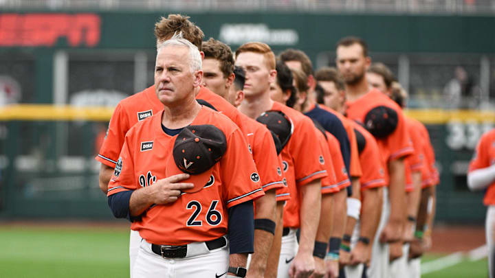 Virginia Cavaliers head coach Brian O'Connor stands for the national anthem before the game against the Florida Gators at Charles Schwab Field Omaha.