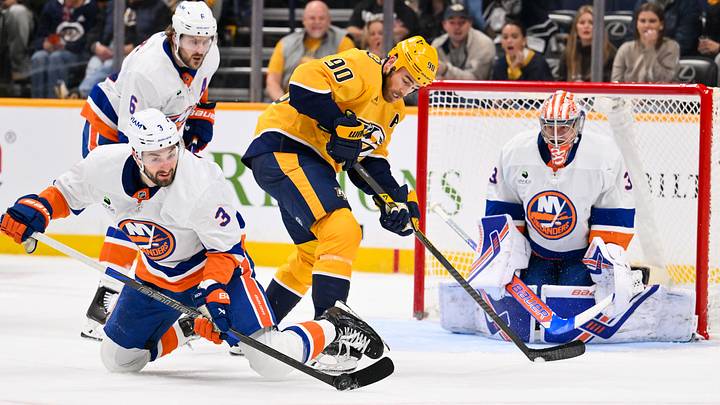 Jan 8, 2026; Nashville, Tennessee, USA; Nashville Predators center Ryan O'Reilly (90) and New York Islanders defenseman Adam Pelech (3) battle for the puck during the third period at Bridgestone Arena. Mandatory Credit: Steve Roberts-Imagn Images Jan 8, 2026; Nashville, Tennessee, USA; Nashville Predators center Ryan O'Reilly (90) and New York Islanders defenseman Adam Pelech (3) battle for the puck during the third period at Bridgestone Arena. Mandatory Credit: Steve Roberts-Imagn Images