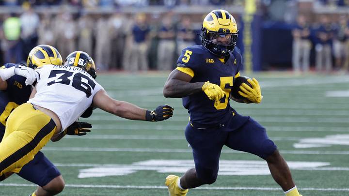Sep 26, 2026; Ann Arbor, Michigan, USA;  Michigan Wolverines running back Savion Hiter (5) runs against Iowa Hawkeyes linebacker Jayden Montgomery (36) during the second half at Michigan Stadium.  Mandatory Credit: Rick Osentoski-Imagn Images