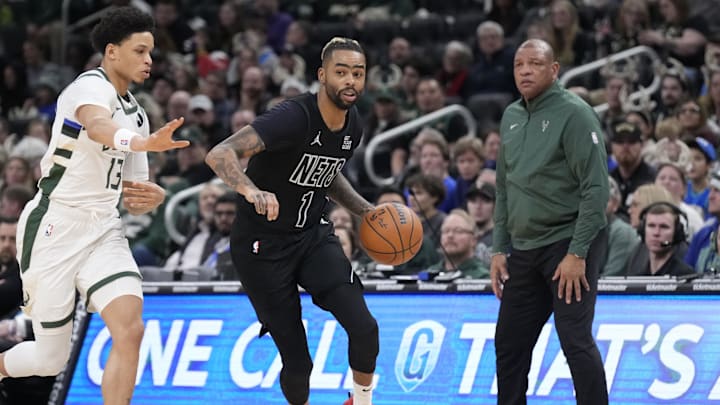 Jan 2, 2025; Milwaukee, Wisconsin, USA; Brooklyn Nets guard D’Angelo Russell (1) drives against Milwaukee Bucks guard Ryan Rollins (13) int the second halfat Fiserv Forum. Mandatory Credit: Michael McLoone-Imagn Images