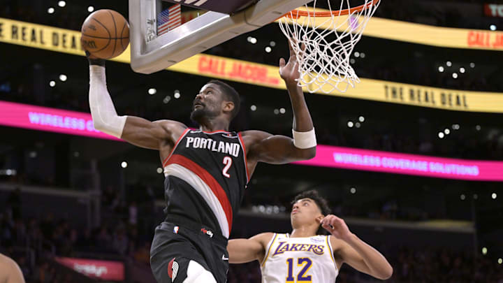 Dec 8, 2024; Los Angeles, California, USA;  Portland Trail Blazers center Deandre Ayton (2) reaches for a pass in front of Los Angeles Lakers guard Max Christie (12) in the first half at Crypto.com Arena. Mandatory Credit: Jayne Kamin-Oncea-Imagn Images