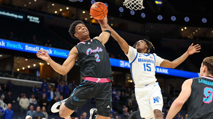 Jan 29, 2026; Memphis, Tennessee, USA; Florida Atlantic Owls guard Isaiah Elohim (2) and Memphis Tigers guard Julius Thedford (15) reach for a rebound during the first half at FedExForum. Mandatory Credit: Wesley Hale-Imagn Images