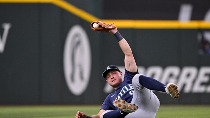Seattle Mariners third baseman Ben Williamson (9) holds up the ball after he makes diving catch on a fly ball hit by Texas Rangers designated hitter Joc Pederson (not pictured) during the first inning at Globe Life Field on May 2.