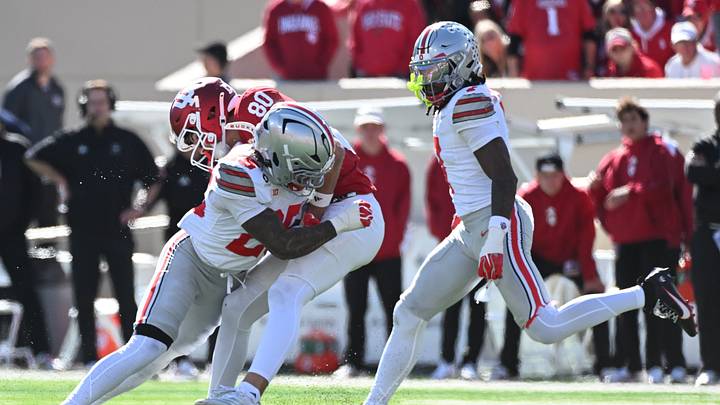 Oct 17, 2026; Bloomington, Indiana, USA;  Indiana Hoosiers wide receiver Charlie Becker (80) is tackled by Ohio State Buckeyes cornerback Jay Timmons (25) during the second half at Merchants Bank Field at Memorial Stadium.  Mandatory Credit: Robert Goddin-Imagn Images