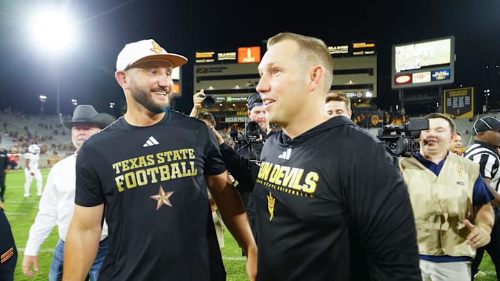 Sep 13, 2025; Tempe, Arizona, USA; Texas State Bobcats head coach G. J. Kinne and Arizona State Sun Devils head coach Kenny Dillingham meet after the game between Arizona State Sun Devils and Texas State Bobcats. Mandatory Credit: Arianna Grainey-Imagn Images