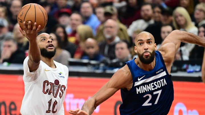 Jan 10, 2026; Cleveland, Ohio, USA; Cleveland Cavaliers guard Darius Garland (10) drives to the basket against Minnesota Timberwolves center Rudy Gobert (27) during the first half at Rocket Arena. Mandatory Credit: Ken Blaze-Imagn Images
