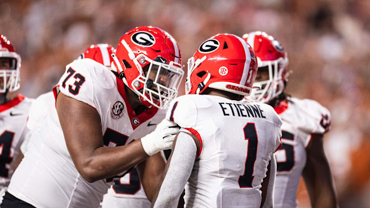 Oct 19, 2024; Austin, Texas, USA; Georgia Bulldogs running back Trevor Etienne (1) celebrates with offensive lineman Xavier Truss (73) after scoring a touchdown against the Texas Longhorns during the second quarter at Darrell K Royal-Texas Memorial Stadium. Mandatory Credit: Brett Patzke-Imagn Images Oct 19, 2024; Austin, Texas, USA; Georgia Bulldogs running back Trevor Etienne (1) celebrates with offensive lineman Xavier Truss (73) after scoring a touchdown against the Texas Longhorns during the second quarter at Darrell K Royal-Texas Memorial Stadium. Mandatory Credit: Brett Patzke-Imagn Images