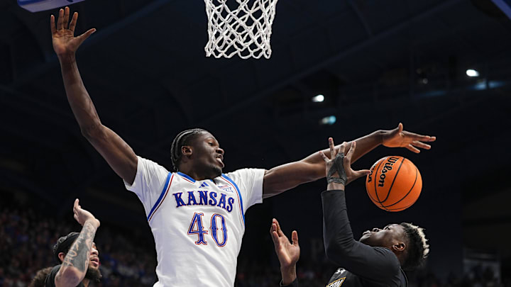 Dec 16, 2025; Lawrence, Kansas, USA; Kansas Jayhawks forward Flory Bidunga (40) and Towson Tigers forward Caleb Embeya (23) fight for a rebound during the second half at Allen Fieldhouse. Mandatory Credit: Jay Biggerstaff-Imagn Images