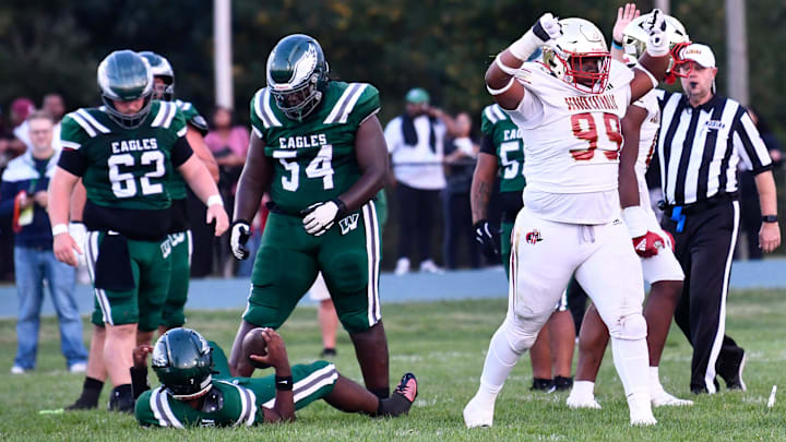 Bergen Catholic's Jayden Beckley, right, celebrates after making a sack during the football game between Bergen Catholic and Winslow played at Winslow Township High School on Friday, September 12, 2025.