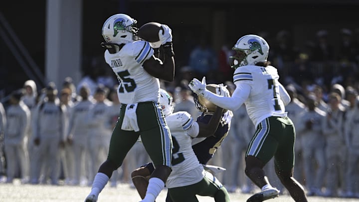 Nov 16, 2024; Annapolis, Maryland, USA;  Tulane Green Wave linebacker Sam Howard (15) catches a Navy Midshipmen tipped pass for a interception during the first half at Navy-Marine Corps Memorial Stadium.