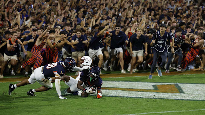 Sep 26, 2025; Charlottesville, Virginia, USA; Virginia Cavaliers defensive back Ja'son Prevard (10) is hugged by Cavaliers defensive back Donavon Platt (28) as fans storm the field after making a game winning interception in the end zone on a pass intended for Florida State Seminoles wide receiver Squirrel White (4) in the second overtime at Scott Stadium. Mandatory Credit: Geoff Burke-Imagn Images