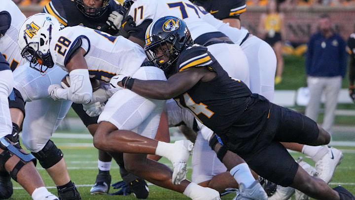 Aug 29, 2024; Columbia, Missouri, USA; Murray State Racers running back Jordan Washington (28) runs the ball as Missouri Tigers linebacker Triston Newson (14) makes the tackle during the game at Faurot Field at Memorial Stadium. Mandatory Credit: Denny Medley-Imagn Images