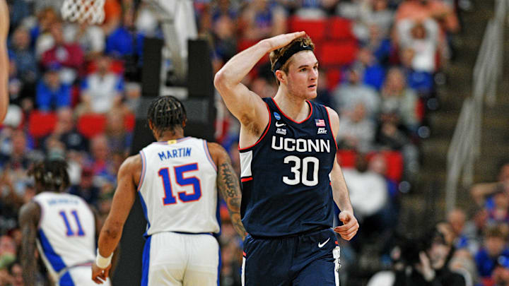 Mar 23, 2025; Raleigh, NC, USA; Connecticut Huskies forward Liam McNeeley (30) reacts after scoring a basket during the second half against the Florida Gators in the second round of the NCAA Tournament at Lenovo Center. Mandatory Credit: Zachary Taft-Imagn Images