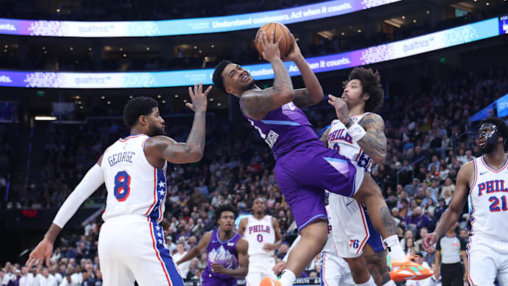 Dec 28, 2024; Salt Lake City, Utah, USA; Utah Jazz forward Brice Sensabaugh (28) goes to the basket between Philadelphia 76ers forward Paul George (8) and guard Kelly Oubre Jr. (9) during the fourth quarter at Delta Center. Mandatory Credit: Rob Gray-Imagn Images