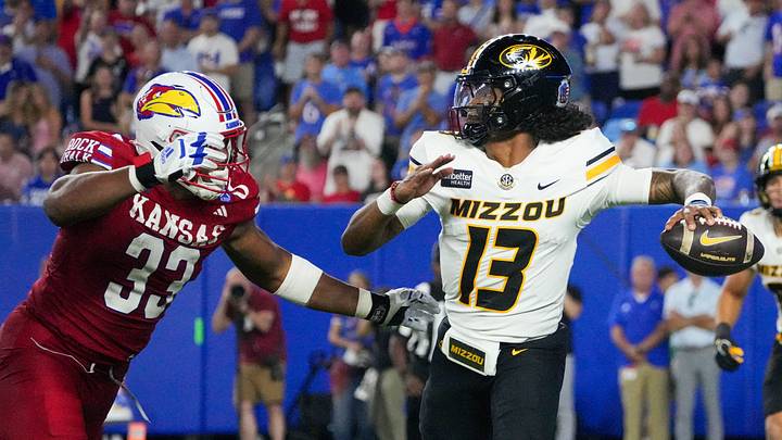 Sep 11, 2026; Lawrence, Kansas, USA; Missouri Tigers quarterback Austin Simmons (13) throws a pass as Kansas Jayhawks defensive end Leroy Harris III (33) defends during the second half of the game at David Booth Kansas Memorial Stadium. Mandatory Credit: Denny Medley-Imagn Images Sep 11, 2026; Lawrence, Kansas, USA; Missouri Tigers quarterback Austin Simmons (13) throws a pass as Kansas Jayhawks defensive end Leroy Harris III (33) defends during the second half of the game at David Booth Kansas Memorial Stadium. Mandatory Credit: Denny Medley-Imagn Images