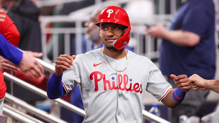 Jun 27, 2025; Atlanta, Georgia, USA; Philadelphia Phillies center fielder Johan Rojas (23) celebrates with teammates after scoring a run against the Atlanta Braves in the ninth inning at Truist Park. Mandatory Credit: Brett Davis-Imagn Images