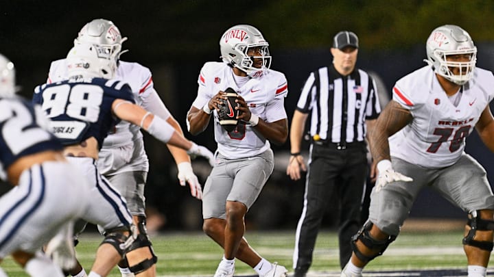 Oct 11, 2024; Logan, Utah, USA;  UNLV Rebels quarterback Hajj-Malik Williams (6) sets up to pass against the Utah State Aggies at Merlin Olsen Field at Maverik Stadium. Mandatory Credit: Jamie Sabau-Imagn Images