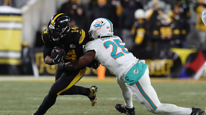 Dec 15, 2025; Pittsburgh, Pennsylvania, USA; Pittsburgh Steelers running back Kenneth Gainwell (14) is tackled by Miami Dolphins linebacker Tyrel Dodson (25) in the third quarter at Acrisure Stadium. Mandatory Credit: Charles LeClaire-Imagn Images
