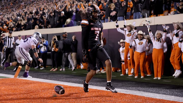 Oct 6, 2023; Stillwater, Oklahoma, USA; Oklahoma State player Cameron Epps (7) returns an interception for a touchdown in front of Kansas State player Hayden Gillum (55) in the first half of the college football game between the Oklahoma State University Cowboys and the Kansas State Wildcats at Boone Pickens Stadium. Mandatory Credit: Sarah Phipps-Imagn Images Oct 6, 2023; Stillwater, Oklahoma, USA; Oklahoma State player Cameron Epps (7) returns an interception for a touchdown in front of Kansas State player Hayden Gillum (55) in the first half of the college football game between the Oklahoma State University Cowboys and the Kansas State Wildcats at Boone Pickens Stadium. Mandatory Credit: Sarah Phipps-Imagn Images