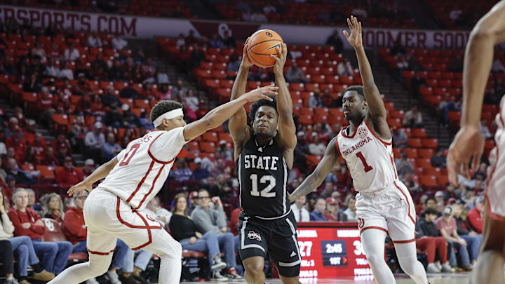 Feb 22, 2025; Norman, Oklahoma, USA; Mississippi State Bulldogs guard Josh Hubbard (12) drives to the basket between Oklahoma Sooners guard Jeremiah Fears (0) and guard Kobe Elvis (1) during the first half at Lloyd Noble Center. Mandatory Credit: Alonzo Adams-Imagn Images Feb 22, 2025; Norman, Oklahoma, USA; Mississippi State Bulldogs guard Josh Hubbard (12) drives to the basket between Oklahoma Sooners guard Jeremiah Fears (0) and guard Kobe Elvis (1) during the first half at Lloyd Noble Center. Mandatory Credit: Alonzo Adams-Imagn Images