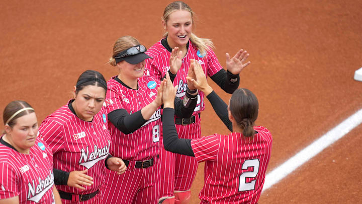 Nebraska's Lauren Camenzind (2) high-fives Nebraska outfielder Abbie Squier (8) during introductions during a NCAA super regionals softball game between the Tennessee Volunteers and Nebraska Cornhuskers at Sherri Parker Lee Stadium in Knoxville, Tenn., on May 25, 2025.