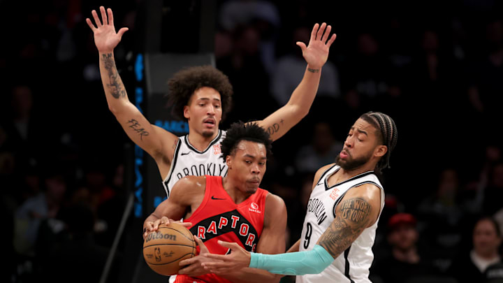 Mar 26, 2025; Brooklyn, New York, USA; Toronto Raptors forward Scottie Barnes (4) controls the ball against Brooklyn Nets forwards Jalen Wilson (22) and Trendon Watford (9) during the second quarter at Barclays Center. Mandatory Credit: Brad Penner-Imagn Images