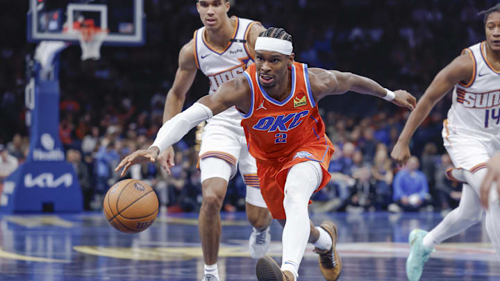 Nov 15, 2024; Oklahoma City, Oklahoma, USA; Oklahoma City Thunder guard Shai Gilgeous-Alexander (2), Phoenix Suns center Oso Ighodaro (4) and guard TyTy Washington Jr. (14) chase after a loose ball during the fourth quarter at Paycom Center. Mandatory Credit: Alonzo Adams-Imagn Images Nov 15, 2024; Oklahoma City, Oklahoma, USA; Oklahoma City Thunder guard Shai Gilgeous-Alexander (2), Phoenix Suns center Oso Ighodaro (4) and guard TyTy Washington Jr. (14) chase after a loose ball during the fourth quarter at Paycom Center. Mandatory Credit: Alonzo Adams-Imagn Images