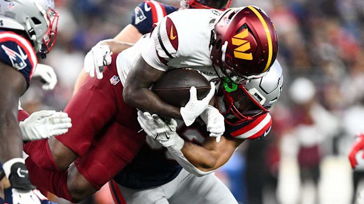 Aug 8, 2025; Foxborough, Massachusetts, USA; Washington Commanders running back Jacory Croskey-Merritt (32) runs against New England Patriots linebacker Christian Elliss (53)  during the first half at Gillette Stadium. Mandatory Credit: Brian Fluharty-Imagn Images