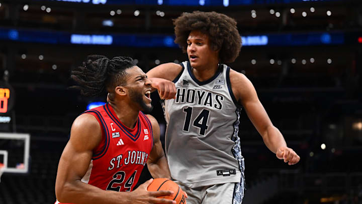 Dec 31, 2025; Washington, District of Columbia, USA; St. John's basketball forward Zuby Ejiofor (24) drives to the basket as Georgetown Hoyas center Seal Diouf (14) defends during the first half at Capital One Arena. Dec 31, 2025; Washington, District of Columbia, USA; St. John's basketball forward Zuby Ejiofor (24) drives to the basket as Georgetown Hoyas center Seal Diouf (14) defends during the first half at Capital One Arena.