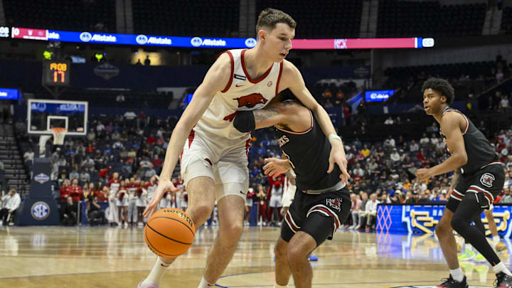 Mar 12, 2025; Nashville, TN, USA;  Arkansas Razorbacks forward Zvonimir Ivisic (44) goes around South Carolina Gamecocks guard Jacobi Wright (1) during the first half at Bridgestone Arena. Mandatory Credit: Steve Roberts-Imagn Images