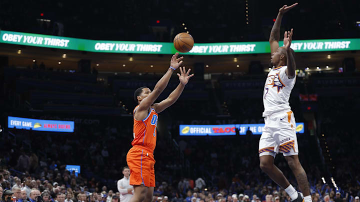 Dec 10, 2025; Oklahoma City, Oklahoma, USA; Oklahoma City Thunder guard Chris Youngblood (3) shoots a three point basket as Phoenix Suns guard Jamaree Bouyea (17) defends during the second half at Paycom Center. Mandatory Credit: Alonzo Adams-Imagn Images Dec 10, 2025; Oklahoma City, Oklahoma, USA; Oklahoma City Thunder guard Chris Youngblood (3) shoots a three point basket as Phoenix Suns guard Jamaree Bouyea (17) defends during the second half at Paycom Center. Mandatory Credit: Alonzo Adams-Imagn Images