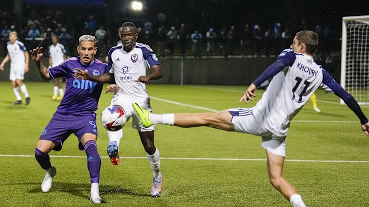 Apr 25, 2023; Matthews, NC, USA; South Georgia Tormenta midfielder Jackson Khoury (11) kicks the ball away from Charlotte FC forward Enzo Copetti (9) during the second half at Mecklenburg County Sportsplex. Mandatory Credit: Jim Dedmon-Imagn Images