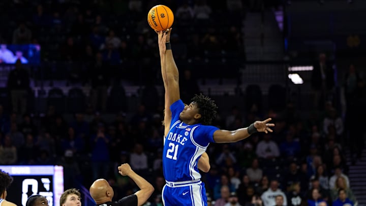 Feb 24, 2026; South Bend, Indiana, USA; Duke Blue Devils center Patrick Ngongba (21) wins the opening tipoff against Notre Dame Fighting Irish forward Carson Towt (33).