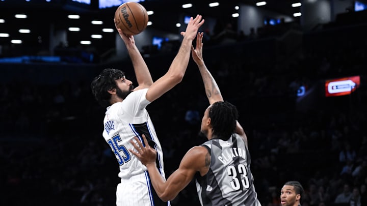 Dec 1, 2024; Brooklyn, New York, USA; Orlando Magic center Goga Bitadze (35) shoots the ball while being defended by Brooklyn Nets center Nic Claxton (33) during the first half at Barclays Center. Mandatory Credit: John Jones-Imagn Images
