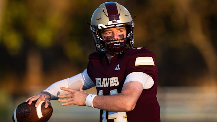 Brebeuf Jesuit Braves' Maverick Geske (14) delivers a pass during warmups Friday, Nov. 1, 2024, ahead of their Class 4A Sectional 22 semifinal game against the Roncalli Royals at St. Vincent Health Field in Indianapolis.
