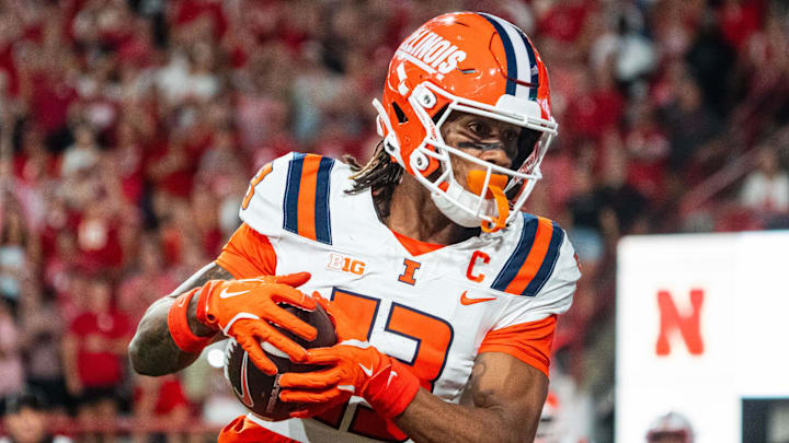 Sep 20, 2024; Lincoln, Nebraska, USA; Illinois Fighting Illini wide receiver Pat Bryant (13) scores a touchdown in overtime against the Nebraska Cornhuskers at Memorial Stadium. Mandatory Credit: Dylan Widger-Imagn Images