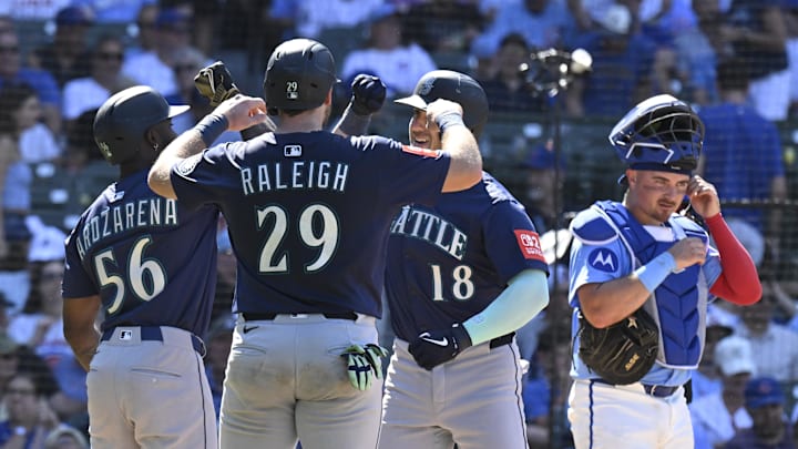 Seattle Mariners designated hitter Mitch Garver (18) celebrates his  three run home run against the Chicago Cubs with outfielder Randy Arozarena (56) and  catcher Cal Raleigh (29) during the ninth inning at Wrigley Field on June 20. 