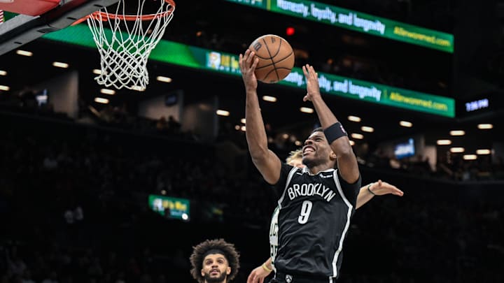 Apr 7, 2026; Brooklyn, New York, USA; Brooklyn Nets forward E.J. Liddell (9) drives past Milwaukee Bucks guard AJ Green (20) during the first half at Barclays Center. Mandatory Credit: John Jones-Imagn Images