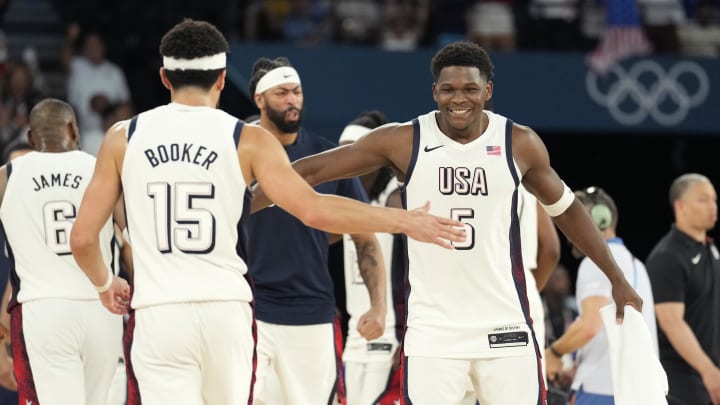 Aug 8, 2024; Paris, France; United States guard Anthony Edwards (5) and guard Devin Booker (15) celebrate during the second half against Serbia in a men's basketball semifinal game during the Paris 2024 Olympic Summer Games at Accor Arena. Mandatory Credit: Kyle Terada-USA TODAY Sports