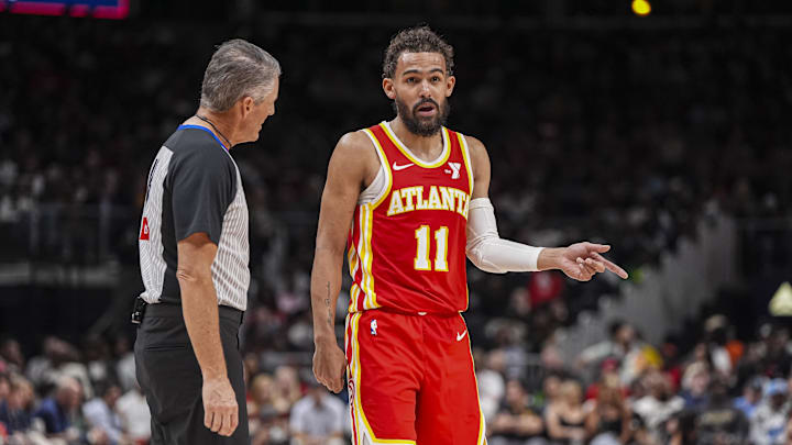 Mar 14, 2025; Atlanta, Georgia, USA; Atlanta Hawks guard Trae Young (11) reacts to official Scott Foster (48) during the game against the LA Clippers during the second half at State Farm Arena. Mandatory Credit: Dale Zanine-Imagn Images