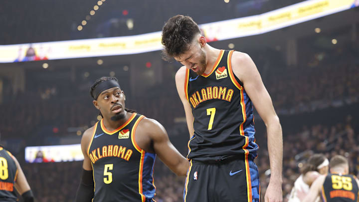 May 5, 2025; Oklahoma City, Oklahoma, USA; Oklahoma City Thunder guard Luguentz Dort (5) checks on forward Chet Holmgren (7) after he was hit during a play against the Denver Nuggets during the first quarter during game one of the second round for the 2025 NBA Playoffs at Paycom Center. Mandatory Credit: Alonzo Adams-Imagn Images
